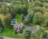 Aerial view of property's location with a pool area and beautiful private pond Aerial view of property's location with a pool area and beautiful private pond