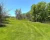Expansive green space featuring a gentle slope Expansive green space featuring a gentle slope