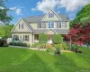 Stunning front porch colonial showcasing exceptional curb appeal, with a lush manicured lawn, mature specimen plantings, and a charming facade. Stunning front porch colonial showcasing exceptional curb appeal, with a lush manicured lawn, mature specimen plantings, and a charming facade.