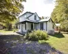 View of property exterior with a yard and a metal roof View of property exterior with a yard and a metal roof