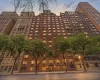 Multi-story brick facade building featuring a stepped architectural design Multi-story brick facade building featuring a stepped architectural design
