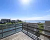 Expansive outdoor deck with wooden railing overlooking a body of water, providing scenic water views Expansive outdoor deck with wooden railing overlooking a body of water, providing scenic water views