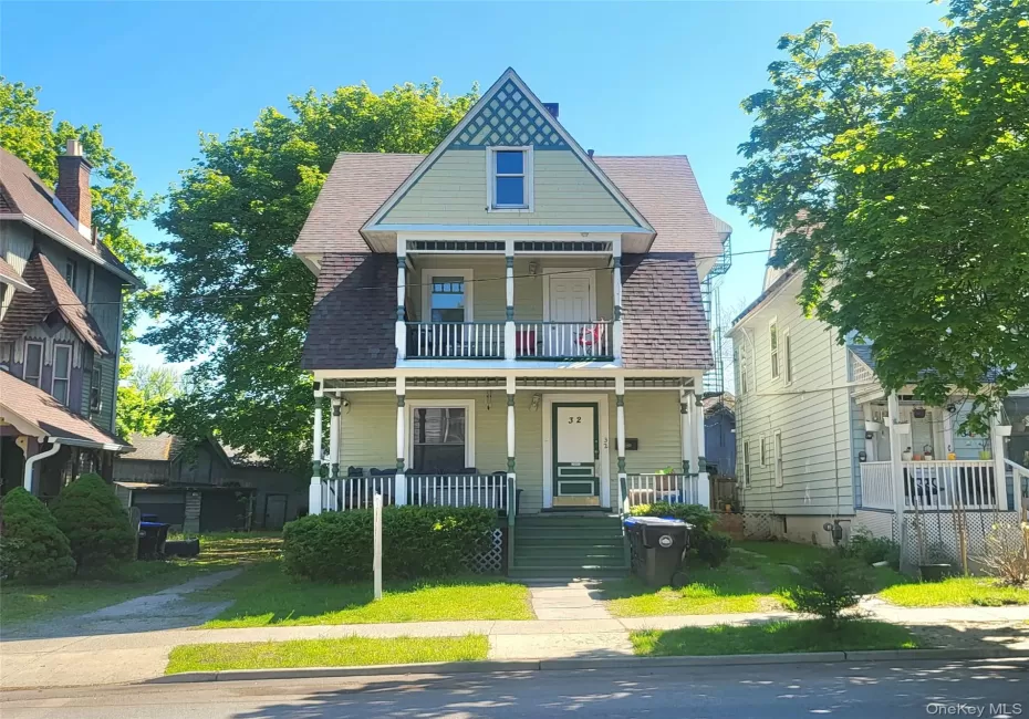 Colonial home.with covered porch, a balcony, and a shingled roof Colonial home.with covered porch, a balcony, and a shingled roof