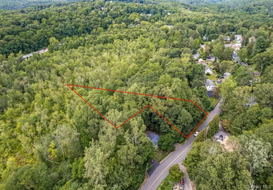 Aerial overview of property's location featuring a heavily wooded area and property parcel outlined Aerial overview of property's location featuring a heavily wooded area and property parcel outlined