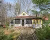 View of front of house with a sunroom and a chimney View of front of house with a sunroom and a chimney