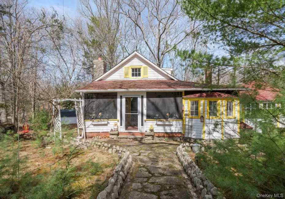 View of front of house with a sunroom and a chimney View of front of house with a sunroom and a chimney