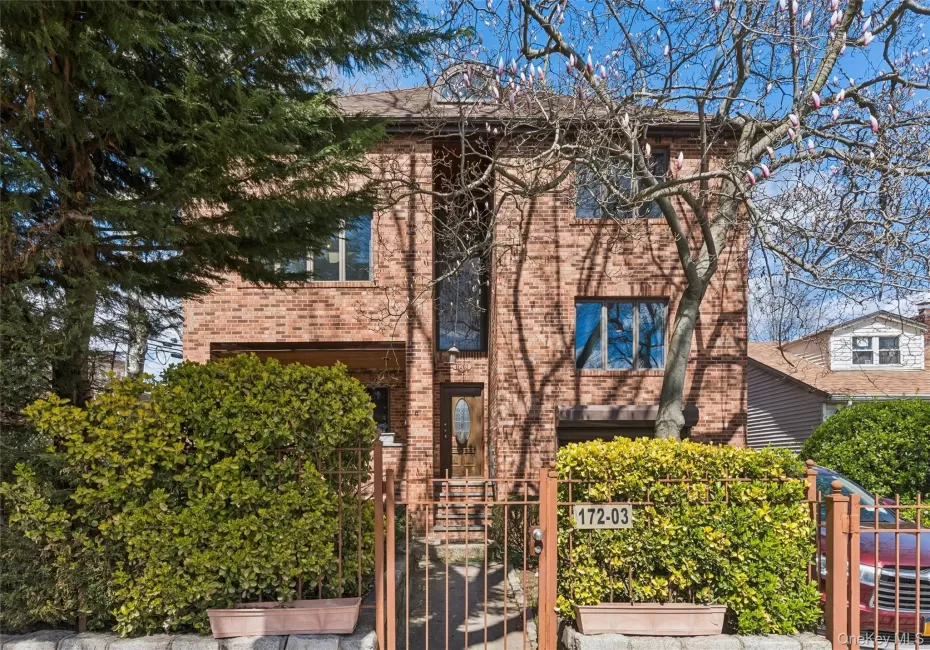 View of front of property with brick siding, a fenced front yard, and a gate View of front of property with brick siding, a fenced front yard, and a gate