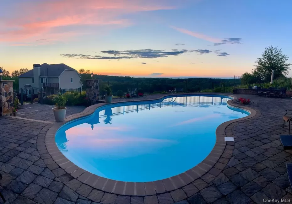 Twilight view of pool and sunset. Twilight view of pool and sunset.