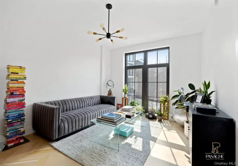 Living room featuring a chandelier Living room featuring a chandelier