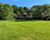 View of front of house with a gambrel roof and a front yard View of front of house with a gambrel roof and a front yard