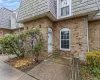 Entrance to property with mansard roof and brick siding Entrance to property with mansard roof and brick siding