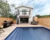 Back of house featuring stairway, outdoor dining space, a deck, and a balcony Back of house featuring stairway, outdoor dining space, a deck, and a balcony