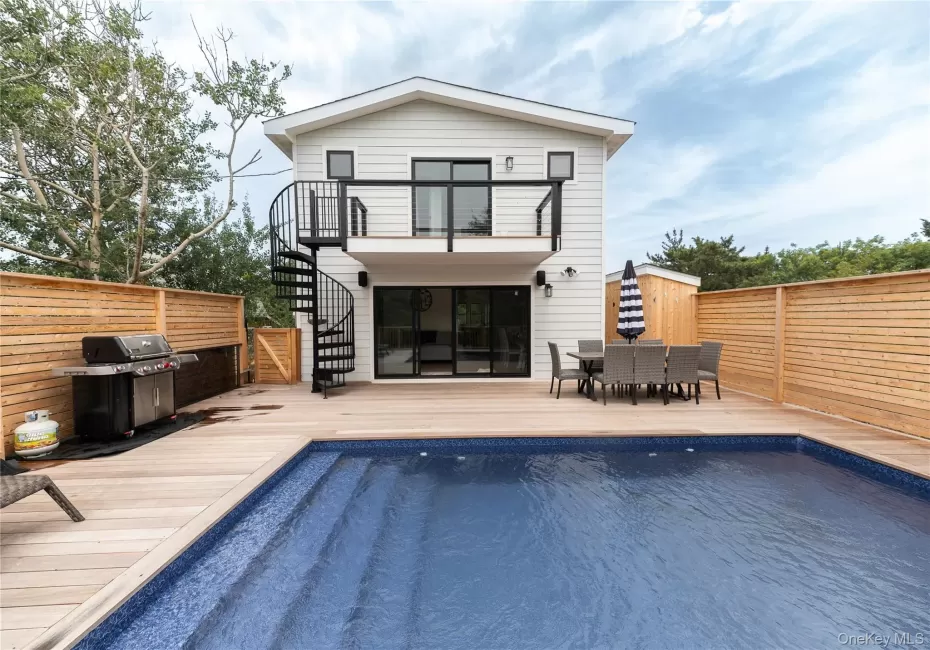 Back of house featuring stairway, outdoor dining space, a deck, and a balcony Back of house featuring stairway, outdoor dining space, a deck, and a balcony