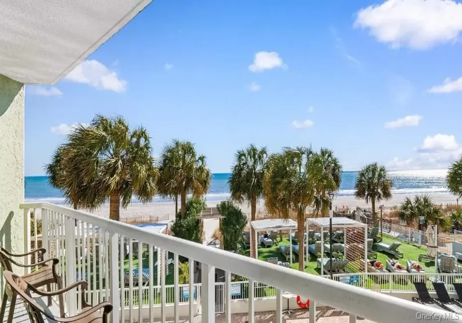 Balcony featuring view of water and beach Balcony featuring view of water and beach