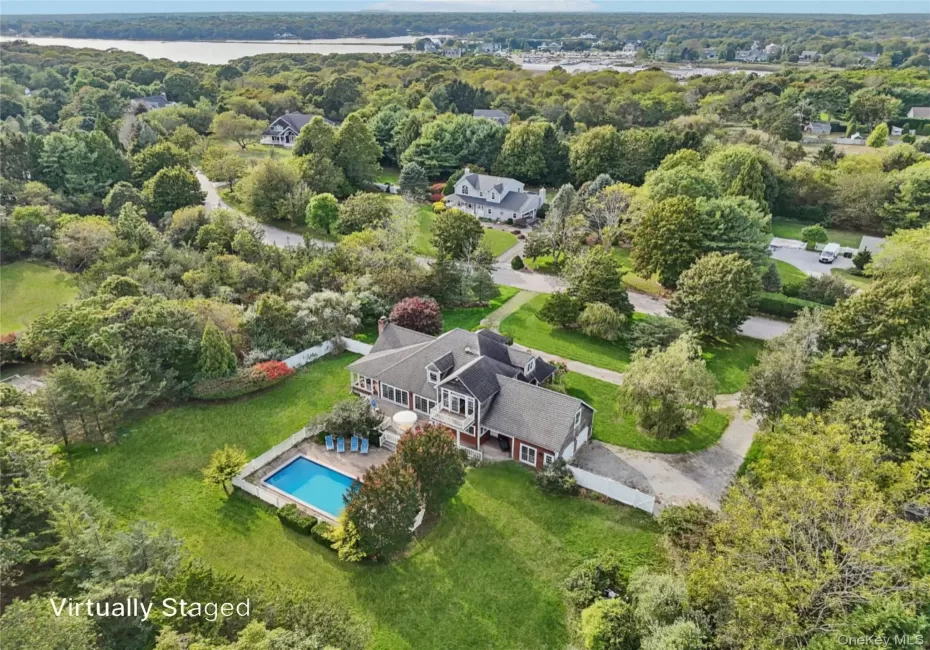 A captivating aerial perspective showcasing the property’s rear elevation, where architecture and landscape blend in perfect harmony. Virtually Staged to show open pool. A captivating aerial perspective showcasing the property’s rear elevation, where architecture and landscape blend in perfect harmony. Virtually Staged to show open pool.