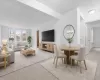 Virtually staged. Living area with light carpet and a chandelier Virtually staged. Living area with light carpet and a chandelier