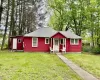 View of front facade featuring a front yard and a shingled roof View of front facade featuring a front yard and a shingled roof