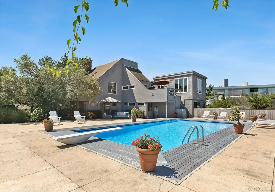 View of swimming pool with a diving board and a patio area View of swimming pool with a diving board and a patio area