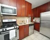 Renovated eat-in-Kitchen has Granite counters, 48" rosewood cabinets and Stainless Steel Appliances including a Dishwasher, microwave, range and refrigerator. Renovated eat-in-Kitchen has Granite counters, 48" rosewood cabinets and Stainless Steel Appliances including a Dishwasher, microwave, range and refrigerator.