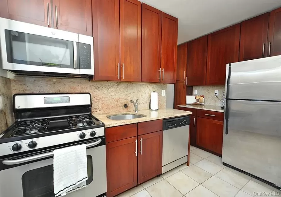 Renovated eat-in-Kitchen has Granite counters, 48" rosewood cabinets and Stainless Steel Appliances including a Dishwasher, microwave, range and refrigerator. Renovated eat-in-Kitchen has Granite counters, 48" rosewood cabinets and Stainless Steel Appliances including a Dishwasher, microwave, range and refrigerator.