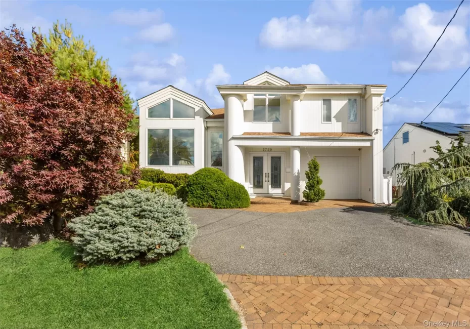 View of front of home with french doors and decorative driveway View of front of home with french doors and decorative driveway
