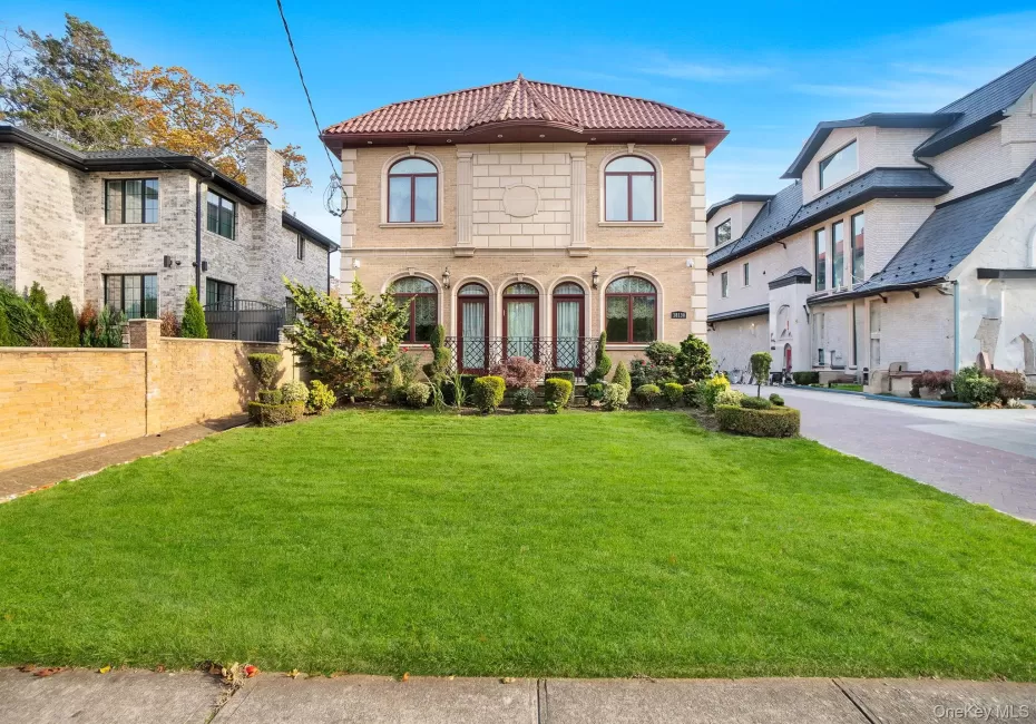 View of front facade featuring a tiled roof and driveway View of front facade featuring a tiled roof and driveway
