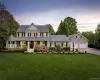 Traditional-style residence featuring a prominent front porch with a rounded gazebo extension, a dormered roofline, and an attached two-car garage Traditional-style residence featuring a prominent front porch with a rounded gazebo extension, a dormered roofline, and an attached two-car garage