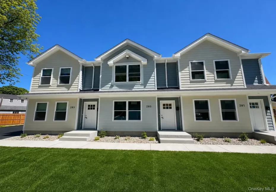 Newly constructed multi-unit property featuring contemporary siding in varied tones Newly constructed multi-unit property featuring contemporary siding in varied tones