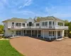 Spacious white cedar residence featuring a multi-level deck and patio Spacious white cedar residence featuring a multi-level deck and patio