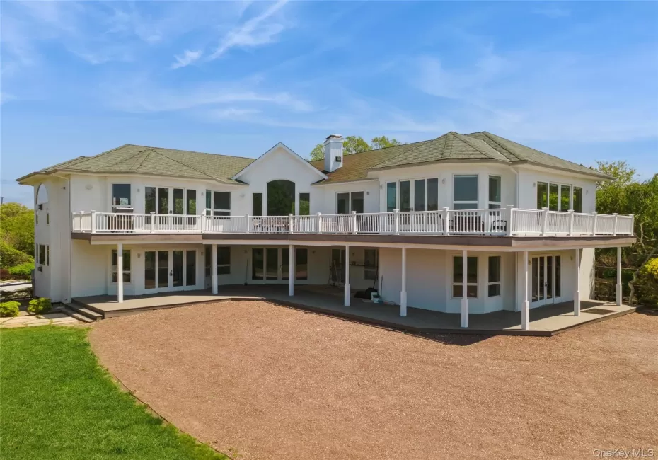 Spacious white cedar residence featuring a multi-level deck and patio Spacious white cedar residence featuring a multi-level deck and patio
