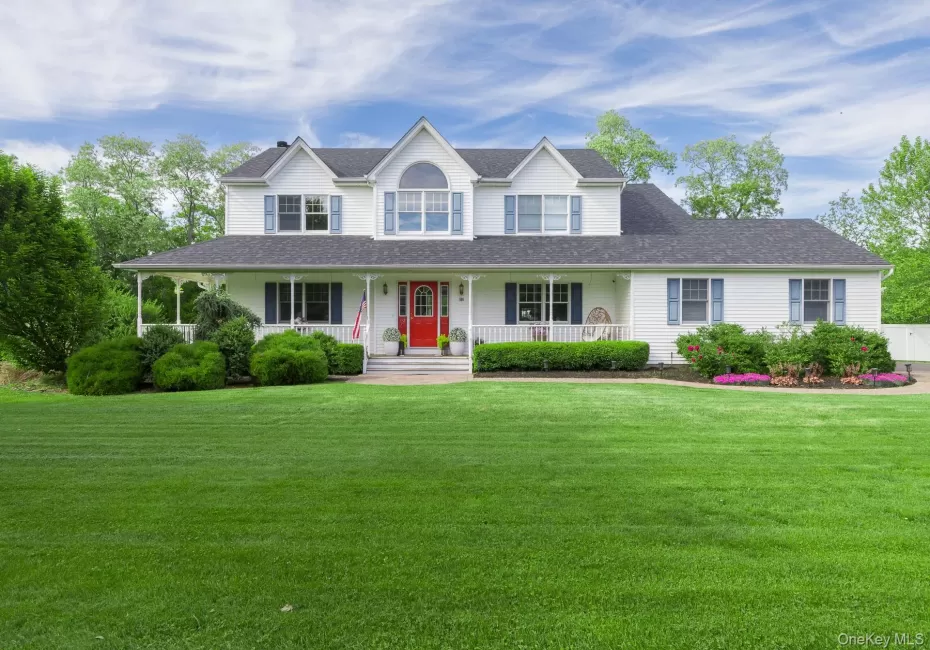 Stunning curb appeal featuring a classic white exterior, a prominent red front door, a covered porch, and beautiful dormer accents." Stunning curb appeal featuring a classic white exterior, a prominent red front door, a covered porch, and beautiful dormer accents."