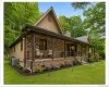Brick and siding exterior with a covered front porch featuring multiple seating areas Brick and siding exterior with a covered front porch featuring multiple seating areas