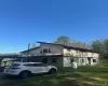 View of side of home featuring a lawn View of side of home featuring a lawn