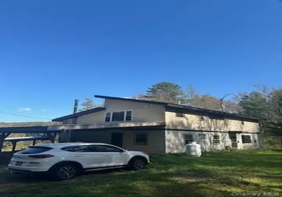 View of side of home featuring a lawn View of side of home featuring a lawn
