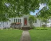 Light-colored siding exterior with white window shutters Light-colored siding exterior with white window shutters