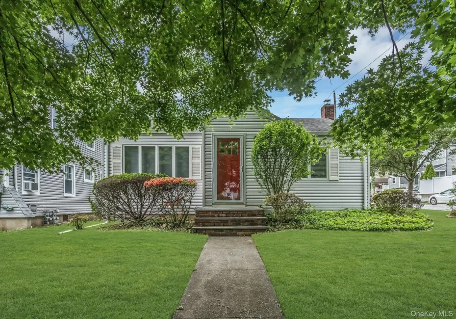 Light-colored siding exterior with white window shutters Light-colored siding exterior with white window shutters