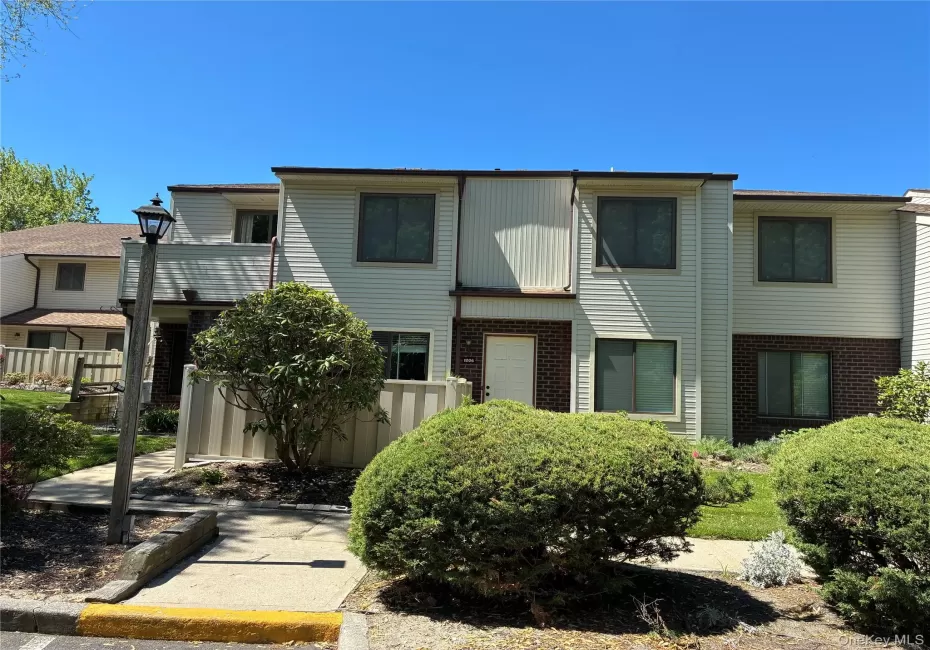 Outside front view of UPPER unit condo showing attached Balcony to the left and showing sidewalk (short walk) to Parking Lot Outside front view of UPPER unit condo showing attached Balcony to the left and showing sidewalk (short walk) to Parking Lot