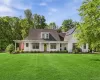 Font exterior showcasing the modern farmhouse design and expansive front lawn Font exterior showcasing the modern farmhouse design and expansive front lawn
