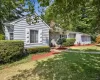 View of front of property with a front lawn and a chimney View of front of property with a front lawn and a chimney