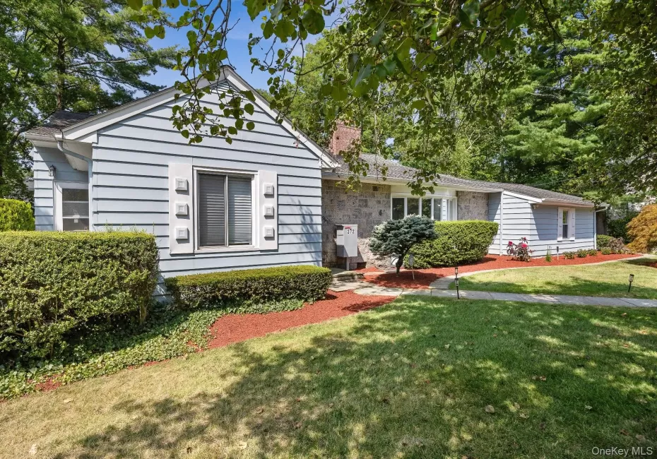View of front of property with a front lawn and a chimney View of front of property with a front lawn and a chimney