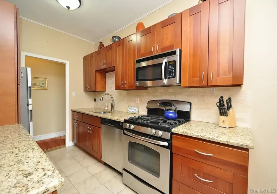 Renovated Eat-in-Kitchen has Granite Counters, Stainless Steel Appliances, Cherry Cabinets and a window for ventilation and natural light. Renovated Eat-in-Kitchen has Granite Counters, Stainless Steel Appliances, Cherry Cabinets and a window for ventilation and natural light.