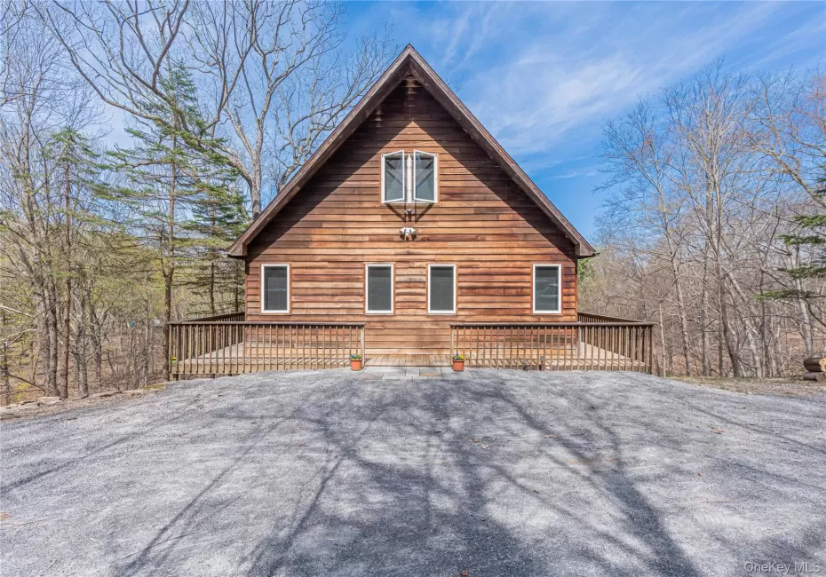 View of home's exterior featuring a wooden deck View of home's exterior featuring a wooden deck
