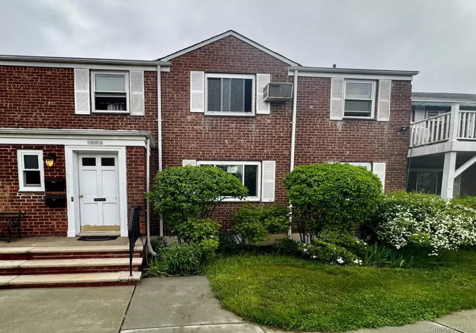Multi unit property with a wall mounted air conditioner and brick siding Multi unit property with a wall mounted air conditioner and brick siding