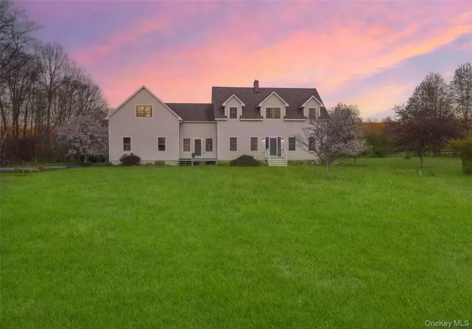 Twilight exterior showcasing the home’s expansive open grounds and peaceful Hudson Valley setting Twilight exterior showcasing the home’s expansive open grounds and peaceful Hudson Valley setting