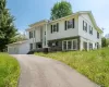 Upper level of residence featuring a two-car detached garage, and a paved driveway Upper level of residence featuring a two-car detached garage, and a paved driveway