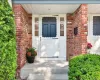 Welcoming covered front entrance with attractive brick exterior and mature landscaping. Welcoming covered front entrance with attractive brick exterior and mature landscaping.