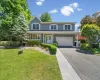 Two-story residential exterior with gray siding and white trim Two-story residential exterior with gray siding and white trim
