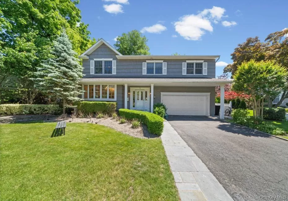 Two-story residential exterior with gray siding and white trim Two-story residential exterior with gray siding and white trim