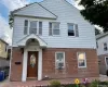 Two-story residence featuring a brick first level and white horizontal siding on the upper level Two-story residence featuring a brick first level and white horizontal siding on the upper level