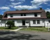 White clapboard siding exterior with a gambrel roof White clapboard siding exterior with a gambrel roof